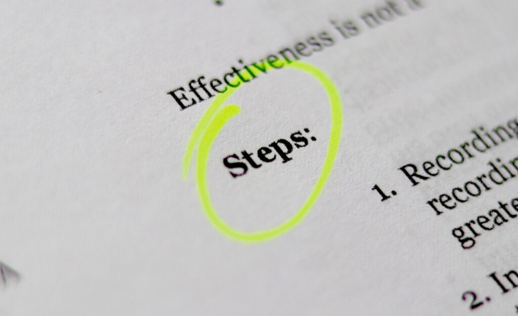 Close-up of a document with the word 'steps:' circled by a neon yellow highlighter.