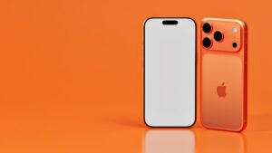 Two iphone‑style smartphones in orange tones on an orange background; one front-facing with a blank white screen, the other showing the orange back with its camera module.